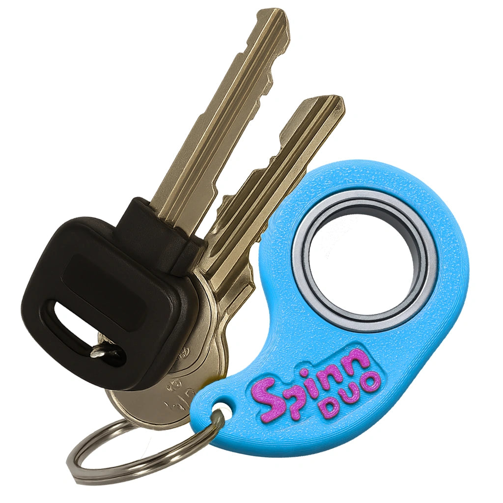 SpinnDuo Cosmic Tide fingertip spinner attached to a keychain, emphasizing compact everyday carry and quick access
