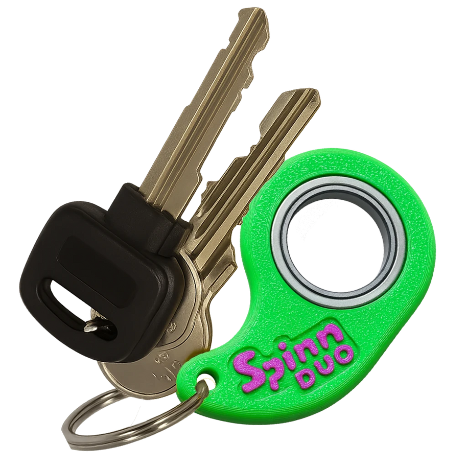 SpinnDuo Neon Bloom spinner attached to a keychain, showing its bright dual-tone style as an everyday personal accessory

